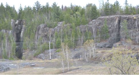 The miners would simply extract the vein material only, leaving the barren hard host diabase on either side.  Note the two vein cuts in the steep cliff walls on either side of this picture taken facing east for town.