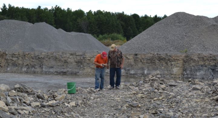Bill Chapman shows Gary Thomas his Isotelus trilobite in Haley Quarry.  The specimen is shown in the lower left of the fossil montage below.